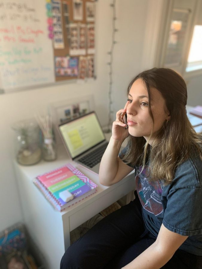 Senior Katie Villani talks on the phone with a caller from the Community Helpline, where she has volunteered for over a year. PHOTO COURTESY OF KATIE VILLANI.