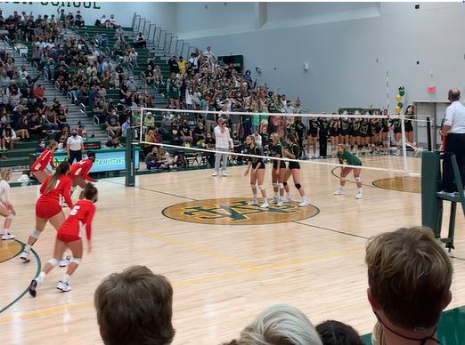 Redondo prepares for a serve that would cause them to lose their first set 25-19. Photo capture by Ty Soria