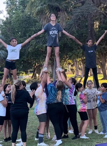 The youth team is practicing stunts during one of their after school sessions. 
Photo by Angela Carlisle. 