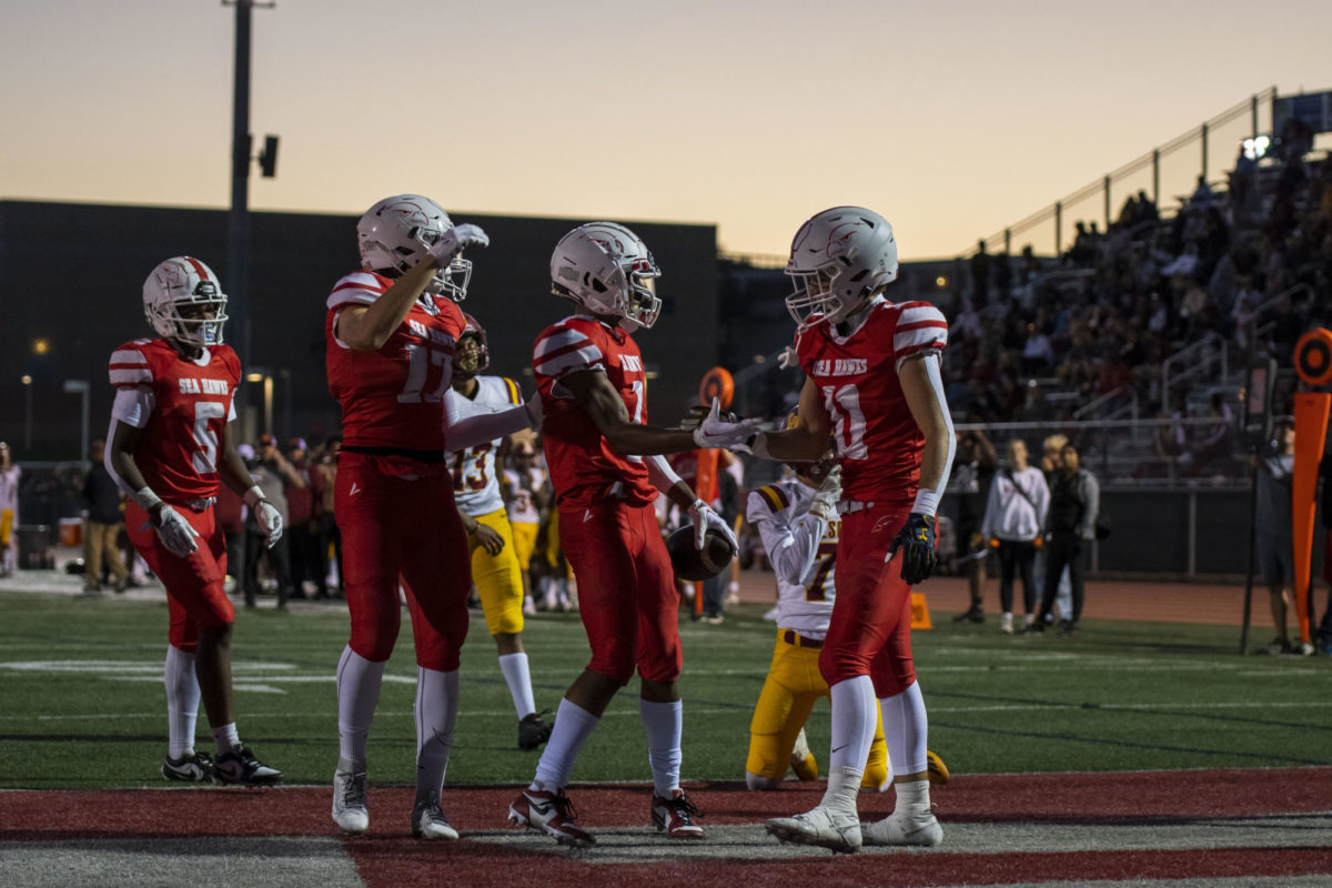 Players+celebrating+after+senior+Cadence+Turner+runs+it+into+the+endzone.%0A%0APhoto+by+Cat+Wong.