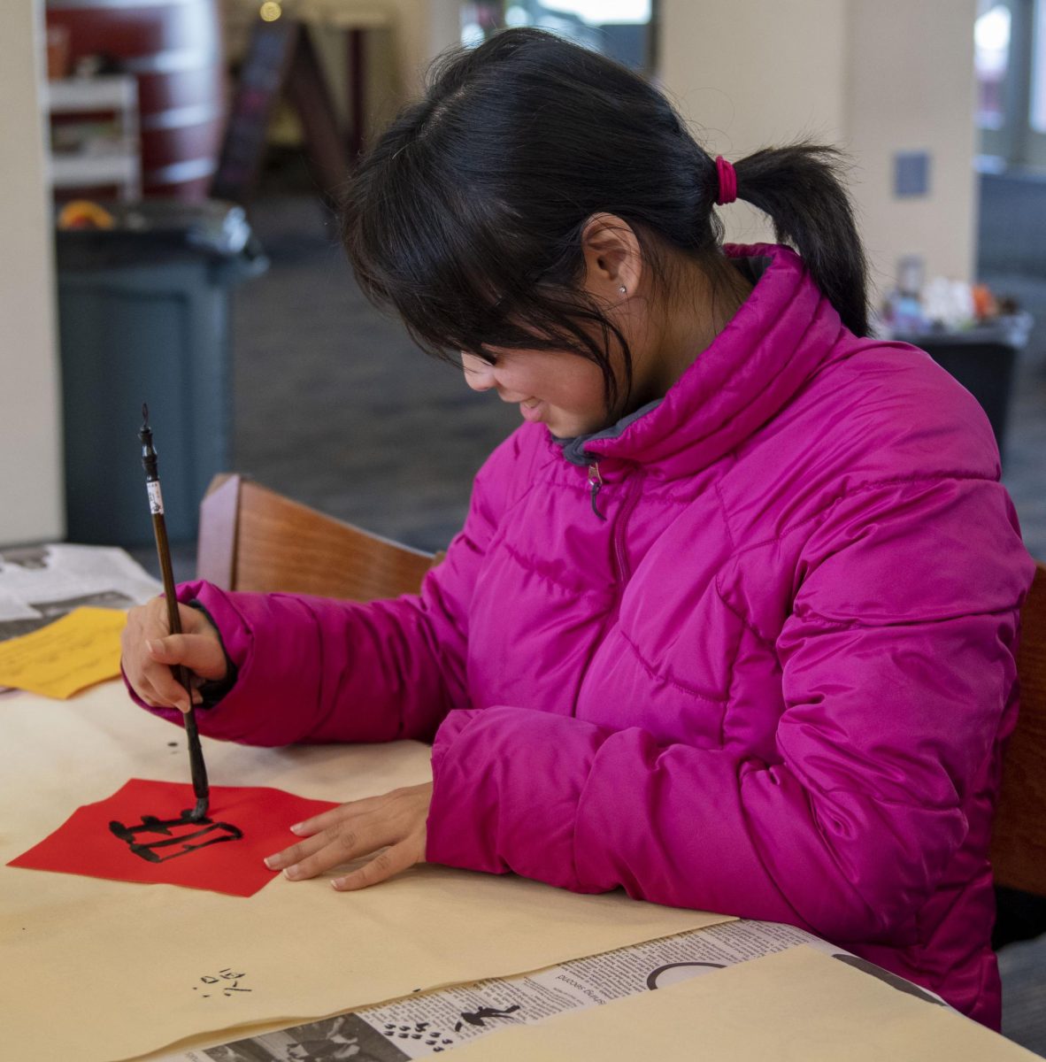 Audrey McFadden practices calligraphy by painting Chinese characters.