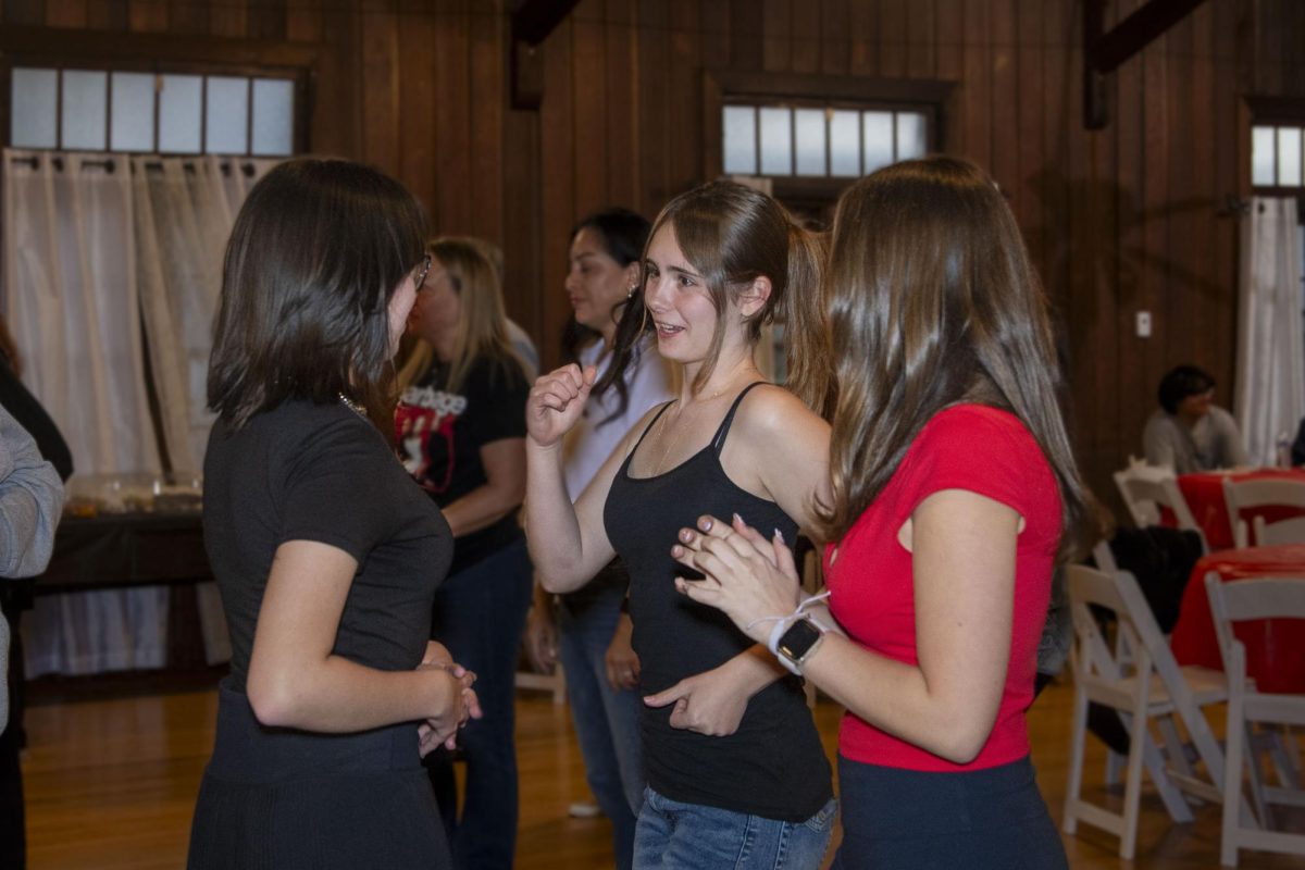 Junior Charlene Elam dances with two friends.