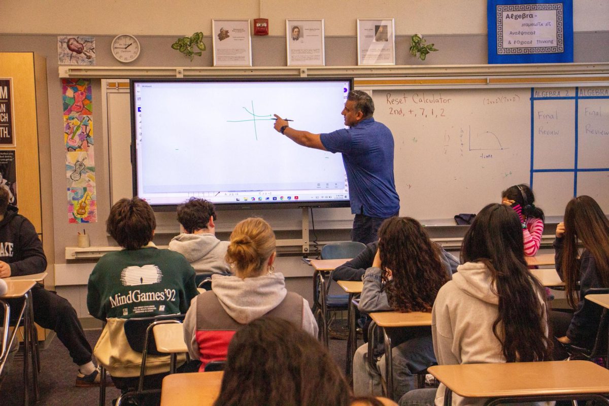 Math teacher Ravi Sangha explaining curriculum to students.