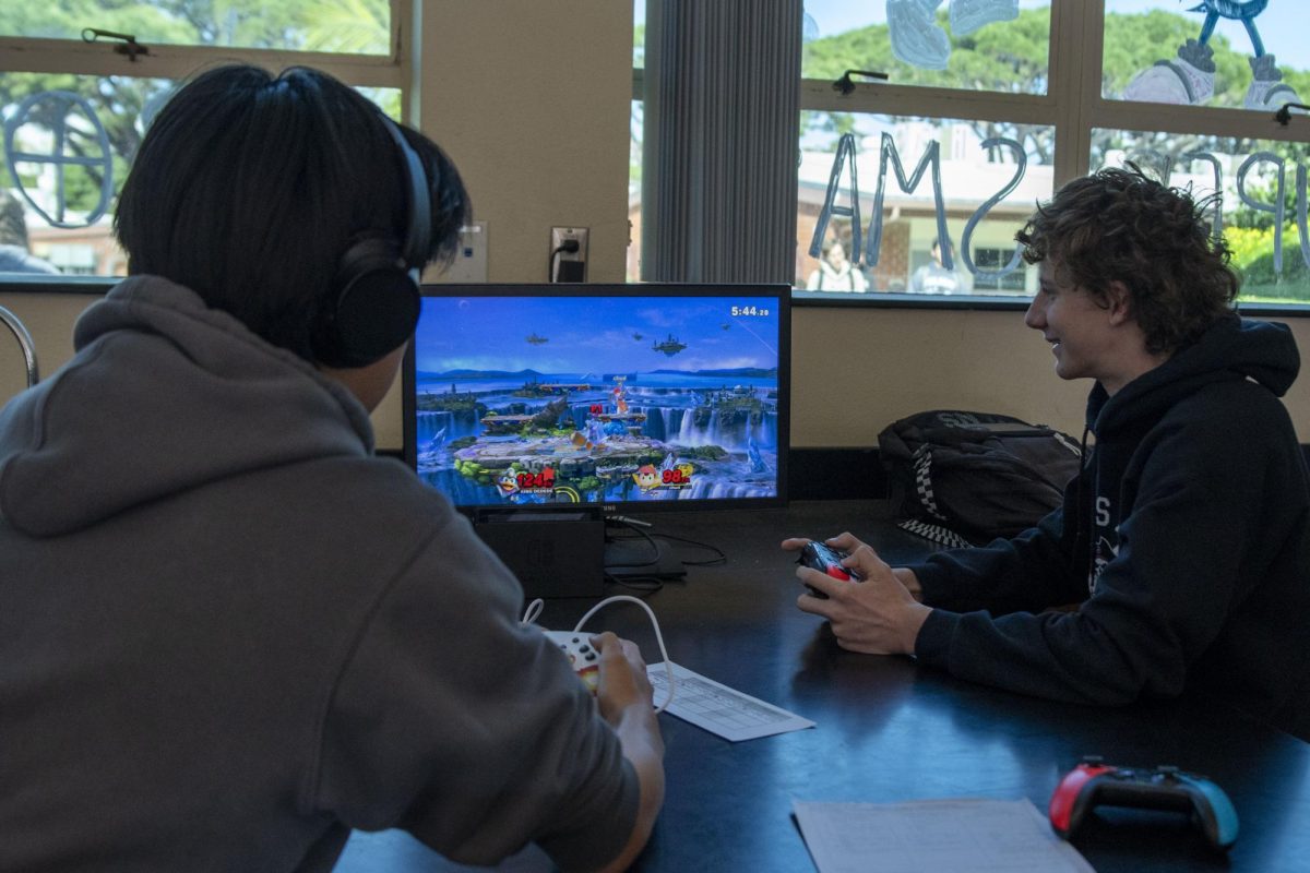 Students compete in Mr. Lewis's classroom to win a match of Super Smash Bros. Ultimate.
